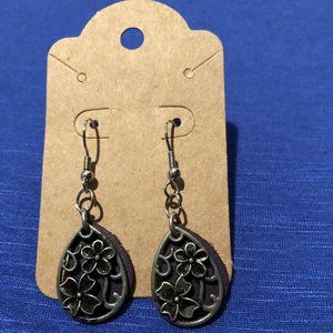 Antiqued Silver Floral Earrings with Purple Suede Background